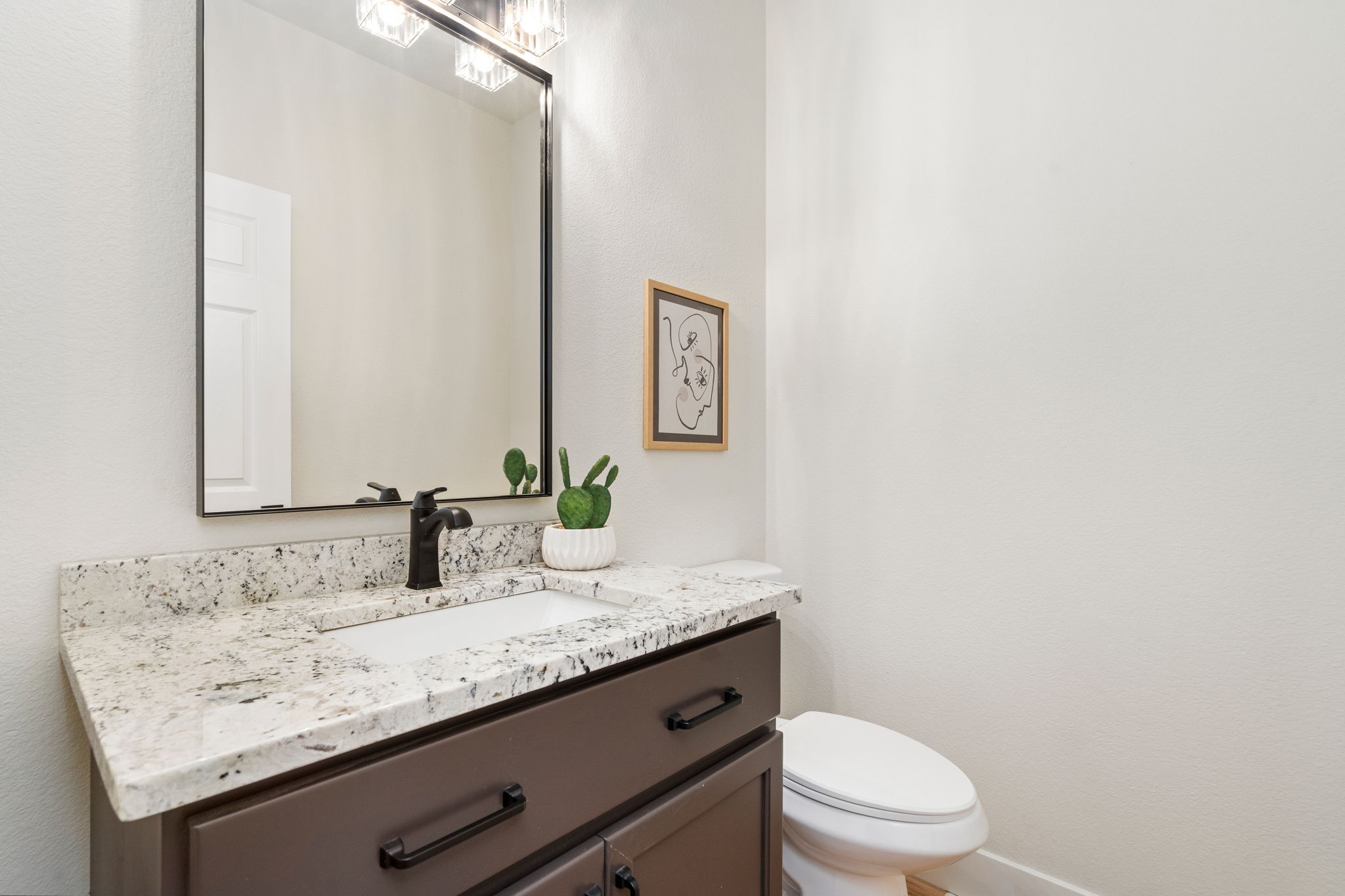 The main floor half-bath is conveniently located near the office/studio.