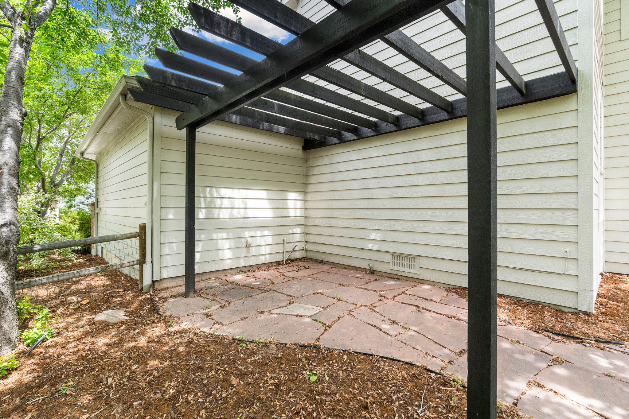 Could be a great space to add a hot tub or set up your grill master space. The views of the green space from this pergola are gorgeous!