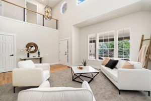 Windows all around and an overlook from the upstairs down to the entryway are luxurious elements.