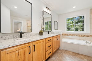 Updated primary bathroom with a luxurious soaking tub and double vanity.