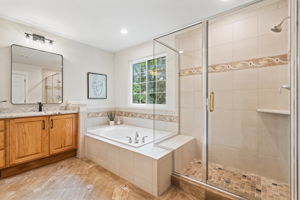 Large walk-in shower and soaking tub are great additions to this spa-like bathroom.