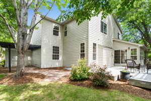 On the other side of the yard is more great lawn space, a flagstone path, and an additional pergola covered patio.