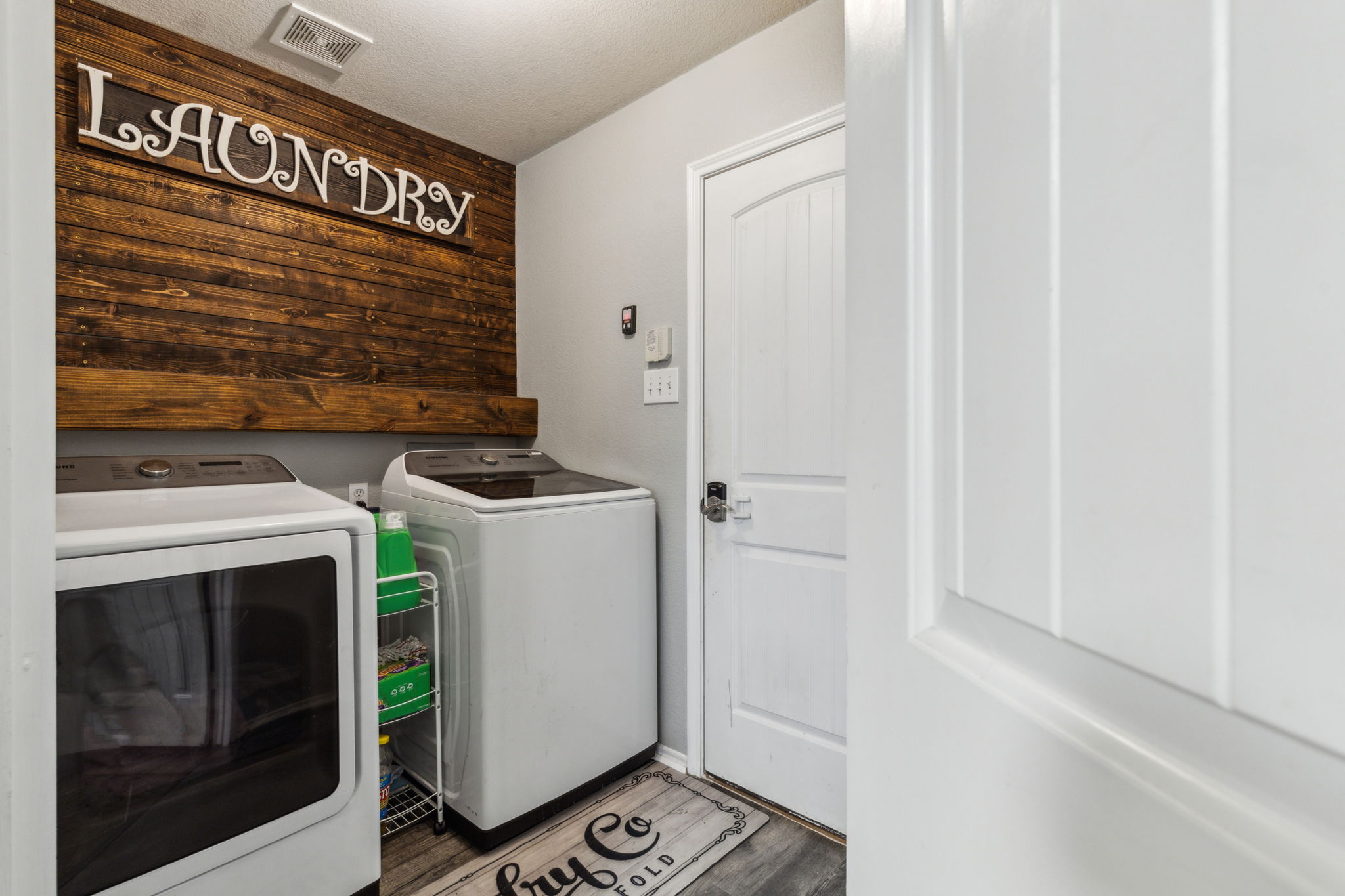 This spacious laundry room is tucked away and yet still convenient to the bedrooms and baths!