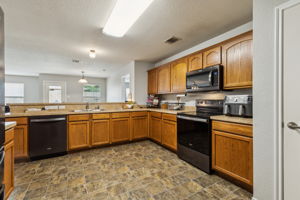 Next, let's check out this Immaculate - Chef's Kitchen! Lots of both cabinets, storage, and counter top! This awesome kitchen also has a sizable pantry!