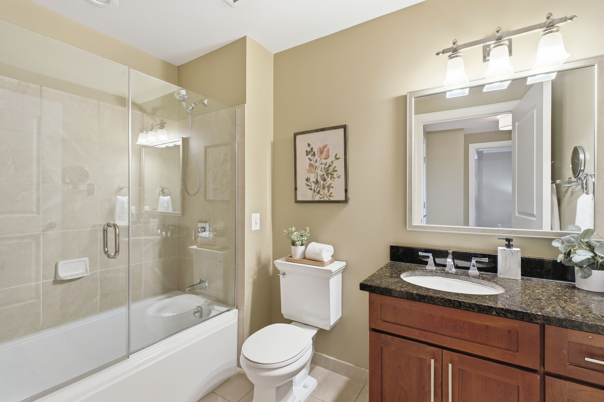 The spacious bathroom has lovely finishes, incl.