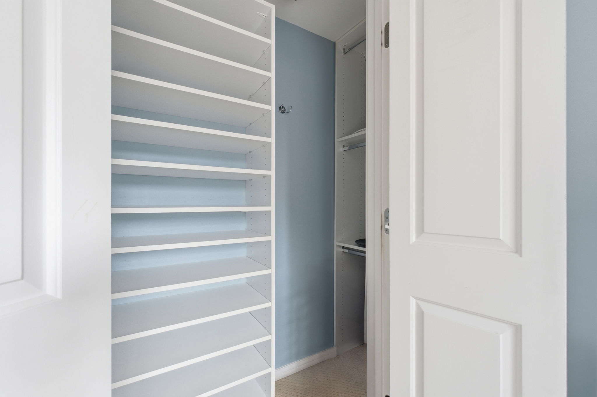 Primary closet has custom built-in shelving system