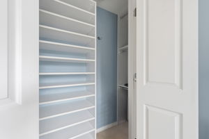 Primary closet has custom built-in shelving system