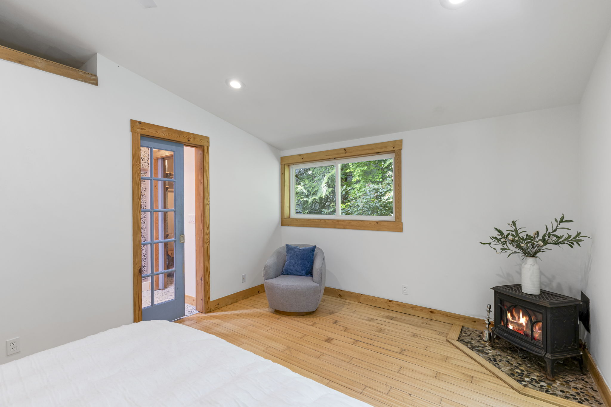 Primary bedroom looking onto the freestanding propane stove and the en-suite!