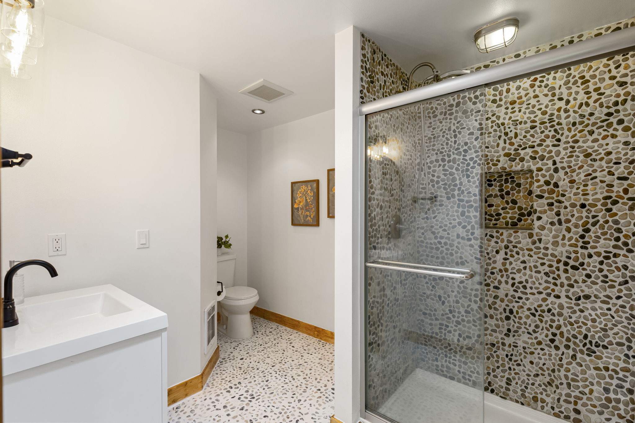 Refreshed primary bathroom...yes those are smooth stones...it's BEAUTIFUL!