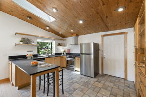 Large kitchen with 'Paper Stone' countertops and tile floors!