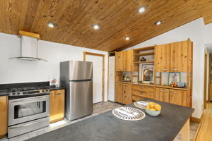 Plenty of storage AND NEW refrigerator, NEW dishwasher and a gas range! Door leads to garage.