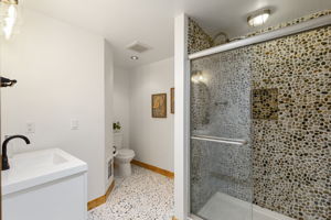 Refreshed primary bathroom...yes those are smooth stones...it's BEAUTIFUL!