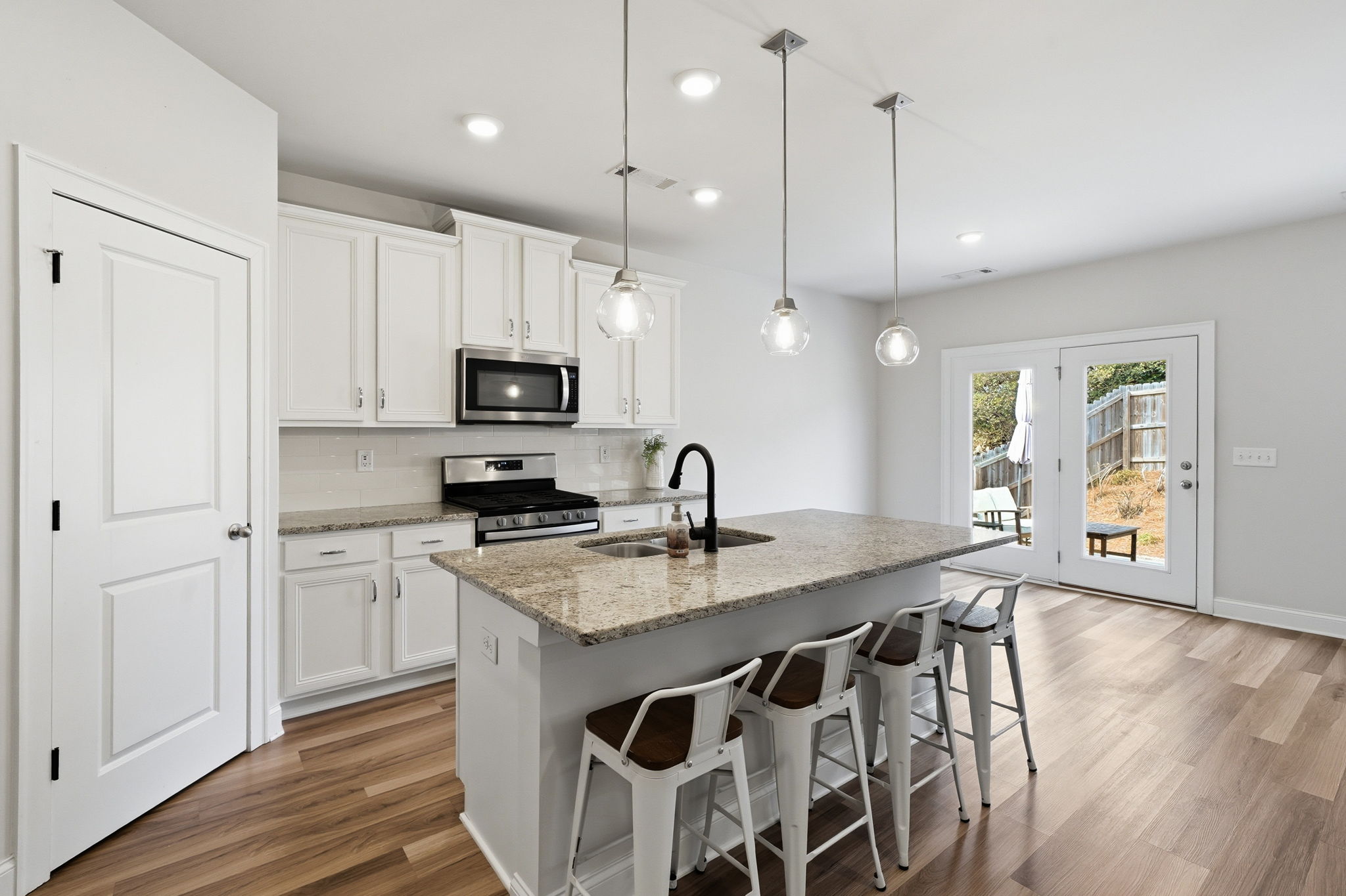 Open floor plan with granite countertops and stainless appliances
