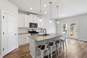 Open floor plan with granite countertops and stainless appliances