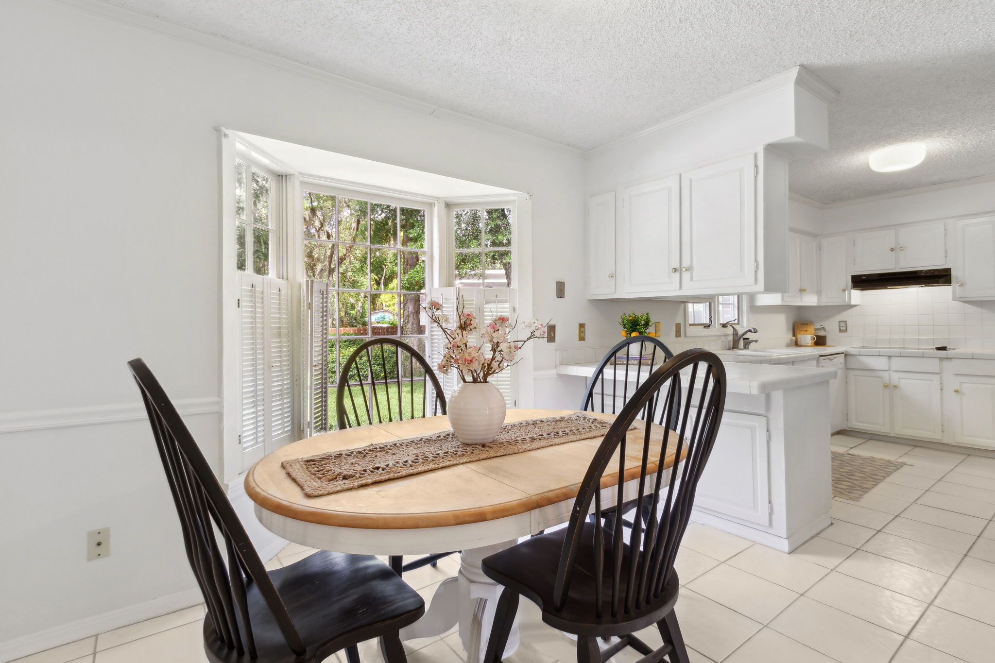 The cheery eat-in kitchen also features a bay window...