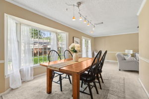 The dining area faces a large bay window...