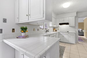 The kitchen is white and bright ...