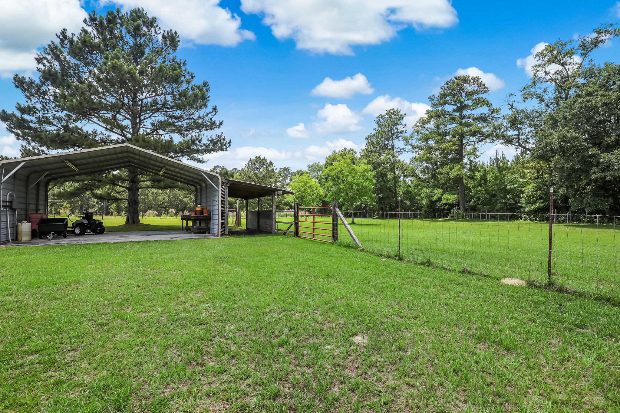 Additional carport and horse run-in shed by pasture