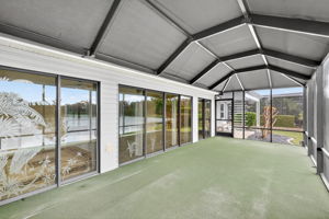 Spacious Rear Screened Porch with Canopy and Adjacent Paver Patio with Pergola