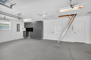 Oversized 2-Car + Golf Cart Garage with Built-In Workbench and Expansive Attic Storage with Plywood Flooring