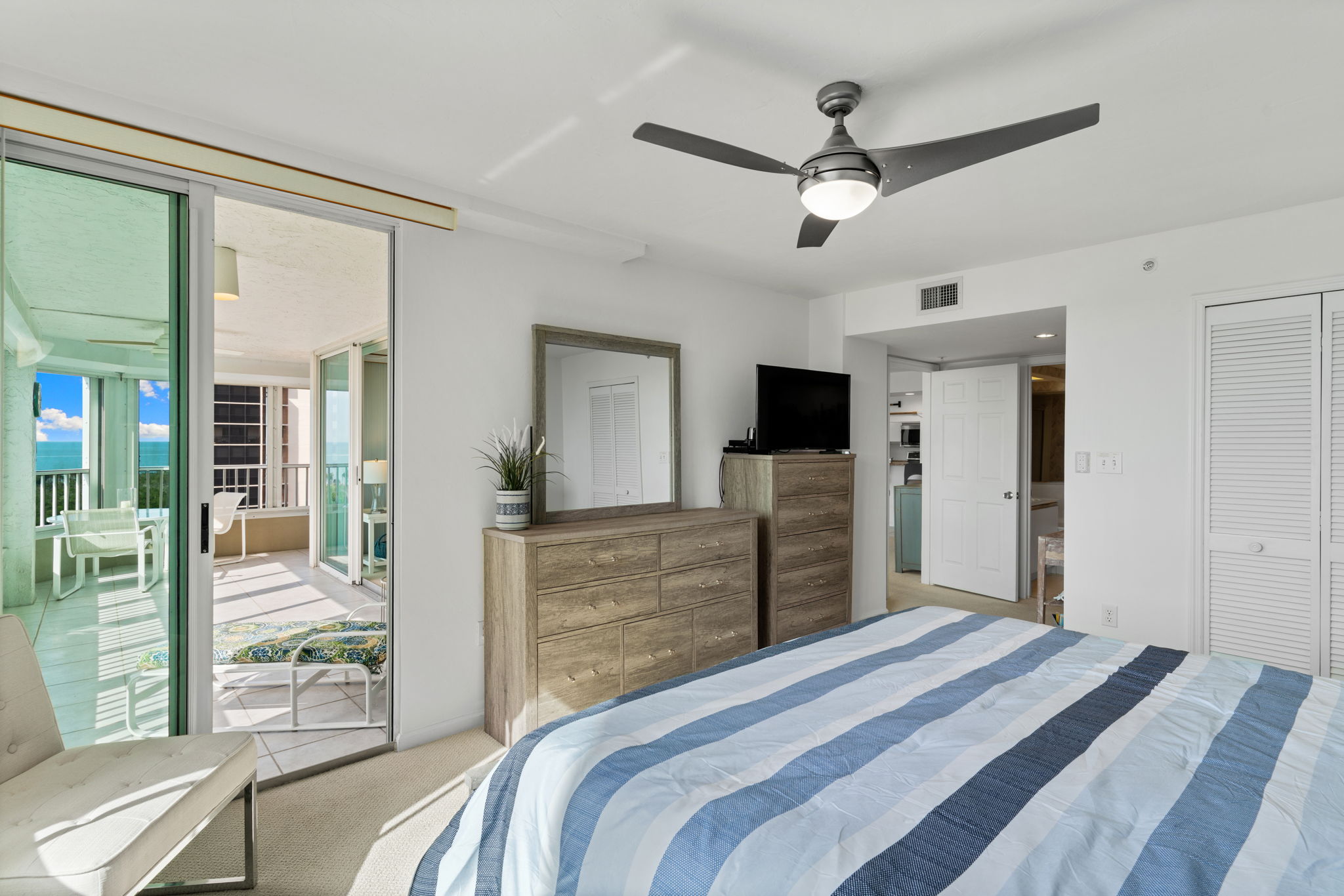 Primary suite with private lanai access, perfect for morning light and coastal breezes