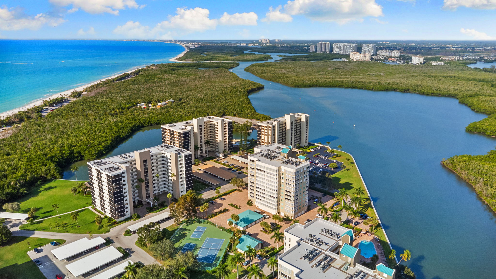 Resort-style amenities including a bayfront pool and pickleball courts
