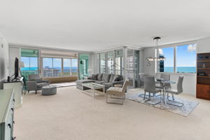 Open living and dining area with expansive glass and sweeping Gulf views.