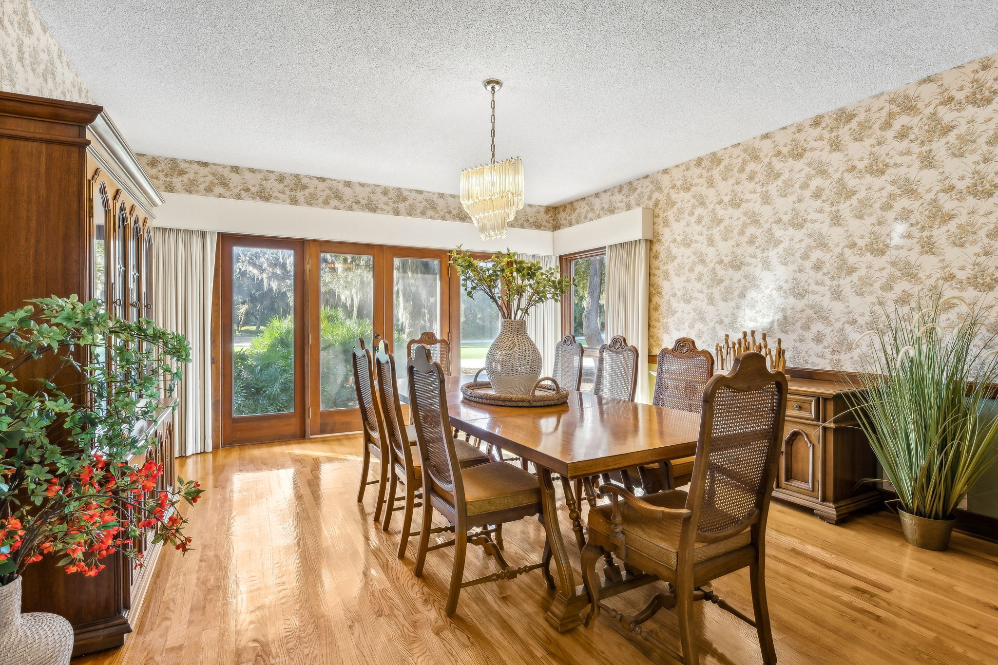 The formal dining just off the kitchen provides sweeping views of the backyard and golf course.