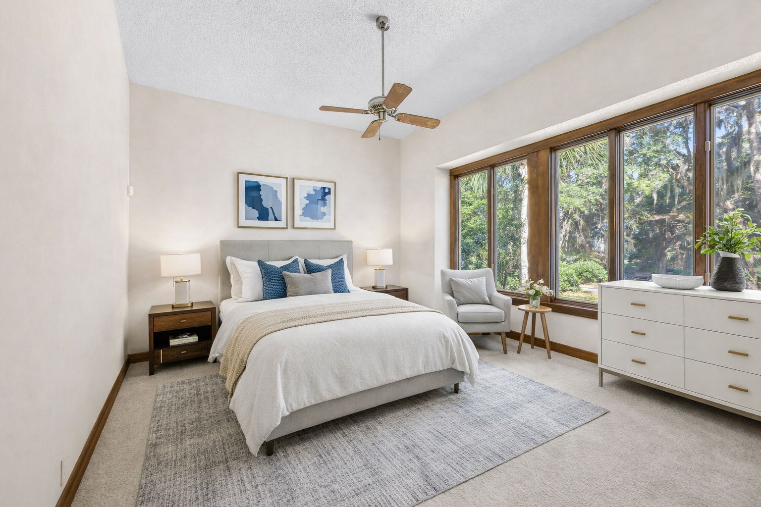 The second guest bedroom features well-placed windows framing scenic views ...