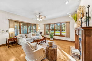 A fireplace anchors the space, complemented by custom cherry built-in shelving ...