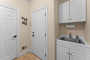Utility Room on First Floor with Entrance to Walk-In Pantry