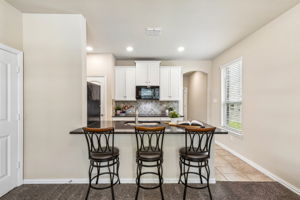 Separate Mother-In-Law Apartment with kitchenette, laundry, one bedroom, and a full bathroom