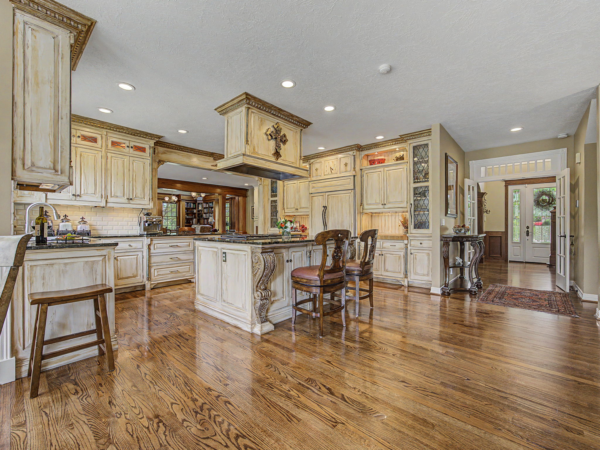 Large open kitchen area and entry view - Custom cabinets
