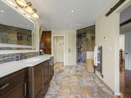 Double sinks and heated floors in the Primary suite bath