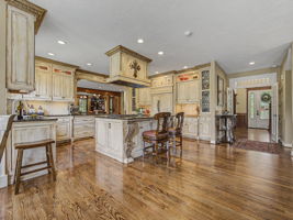 Large open kitchen area and entry view - Custom cabinets