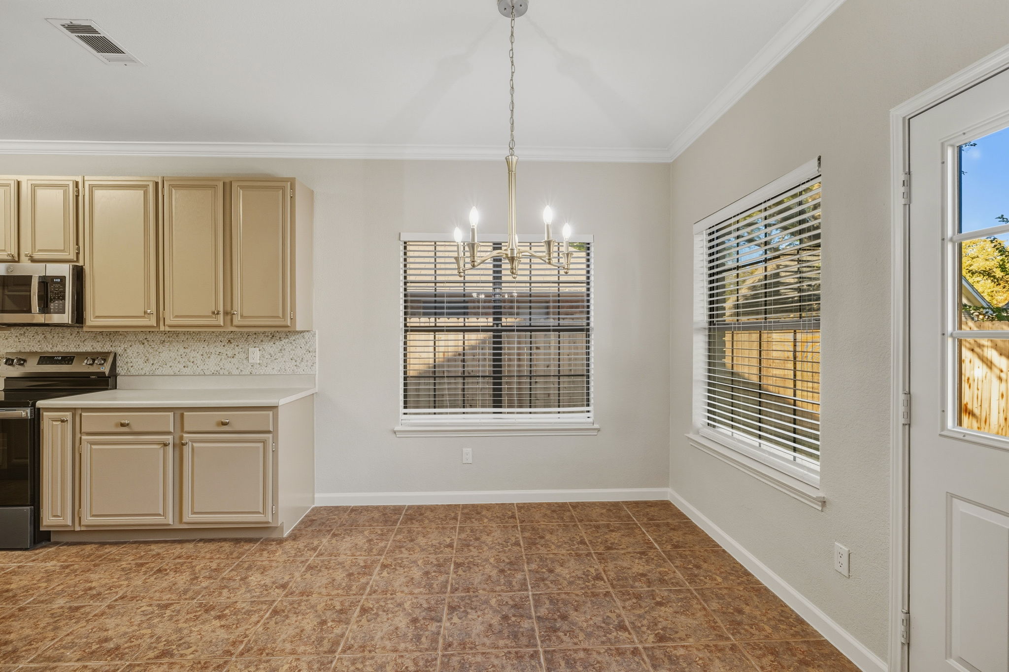 Light & Bright Eat-in Kitchen Area That Opens to Backyard Views—Perfect for Casual Meals and Morning Coffee.