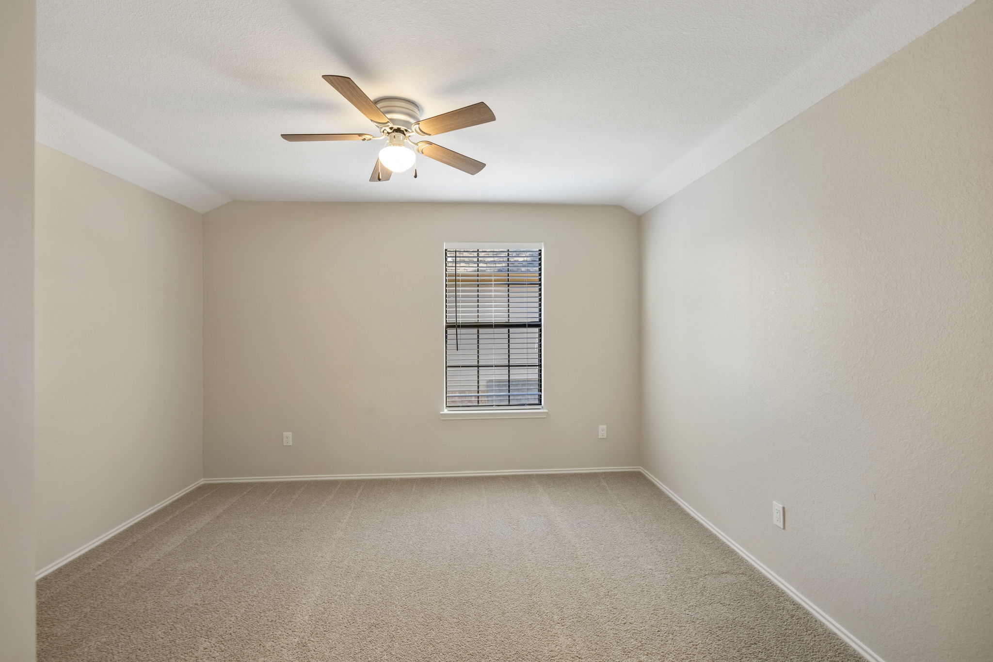 Three Generously Sized Upstairs Guest Bedrooms; Showcasing New Carpet, Modern Window Treatments, and Ceiling Fan For Year-Round Comfort.