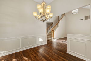 The dining room is open to the formal living area creating a natural separation of spaces without closing anything off.