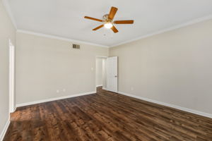 Spacious first-floor primary bedroom suite with sightline toward the entry with continuous easy-care luxury flooring throughout nearly all the main floor living areas.