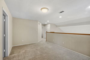 Upstairs Living Area/Game Room Looking Toward The Stairs and The Guest Bathroom.