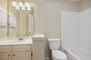 Upstairs Guest Bathroom With Easy-Care Ceramic Tile - All Refreshed with Resurfaced Sink, New Paint and Updated Lighting.