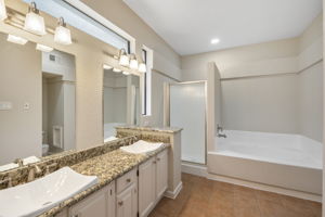 Master Bathroom Sinks and Granite Counter with Separate Shower and Jetted Tub.