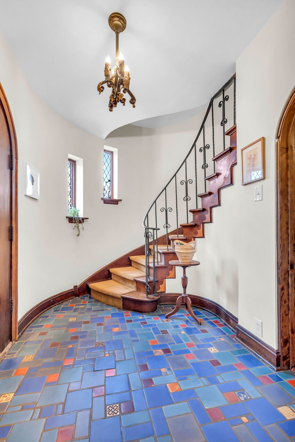 Graceful curved staircase with hand hammered iron railing