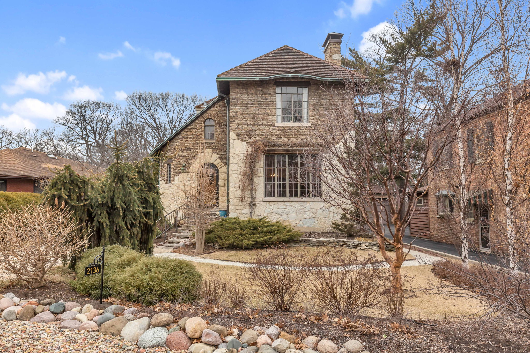 Additional features include: attached garage, brick paver driveway, copper gutters, Ludowici tile roof