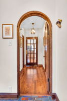 View towards kitchen from foyer, note the elegant arched doorways