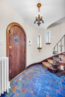 Welcoming foyer with spectacular original tile floor