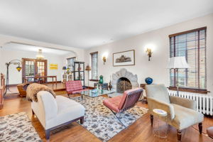 Large sunny sunken living room with wood burning fireplace