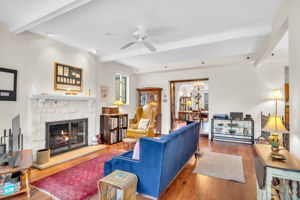 Family room features a wood burning fireplace and opens to wood deck