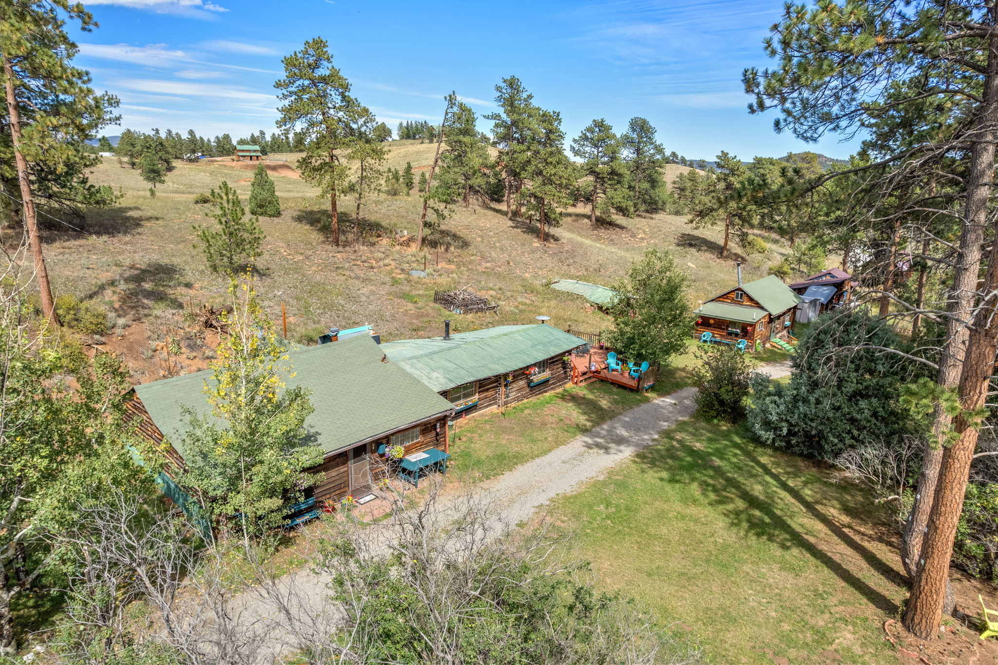 A bird's-eye view of the homestead, showing the main residence, deck & rustic cabin