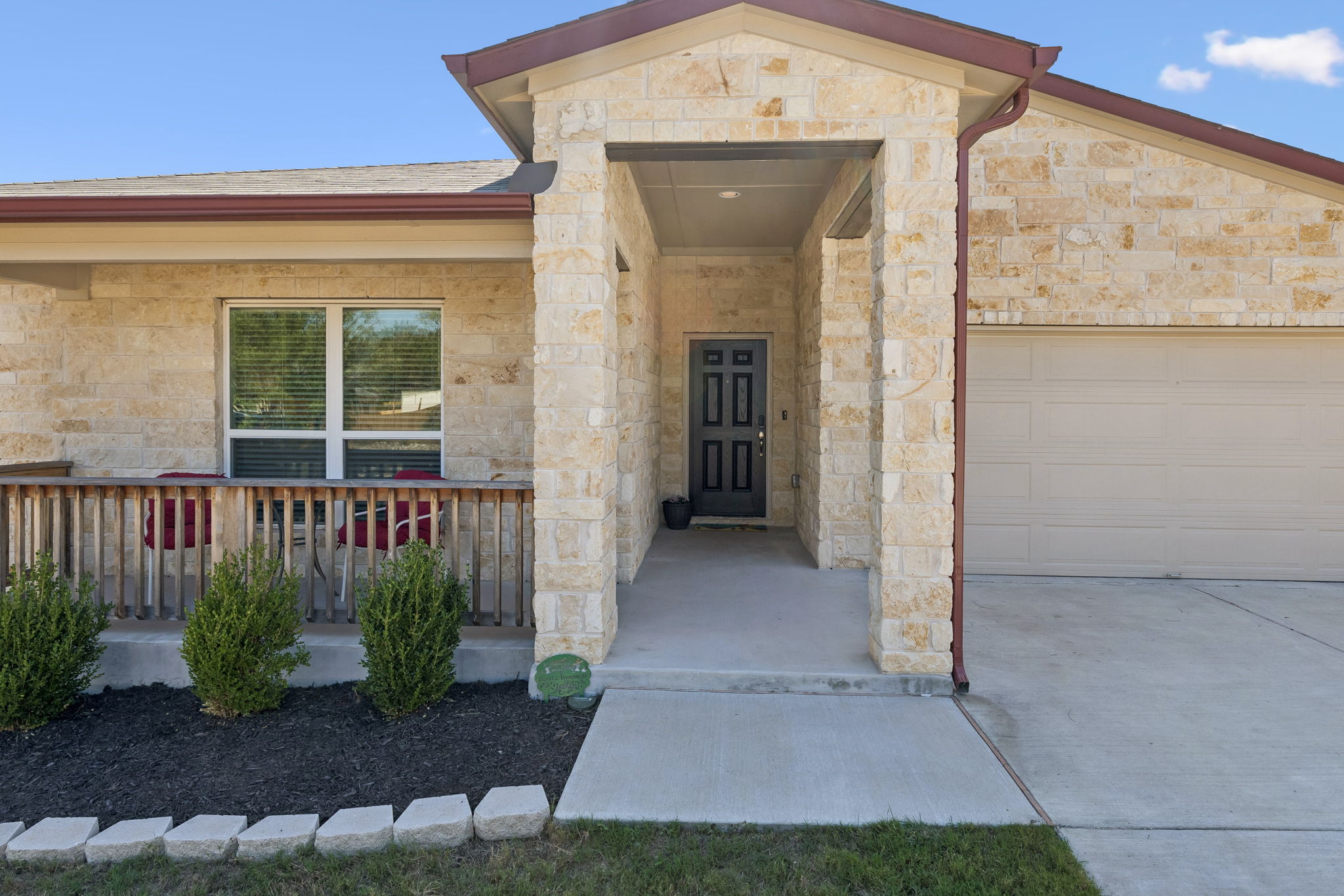 Covered walkway, porch and concrete driveway